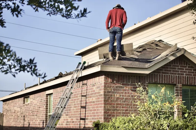 Professional roofer working on a residential roof in University North